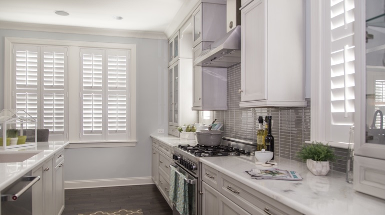 White shutters in Chicago kitchen with white cabinets.